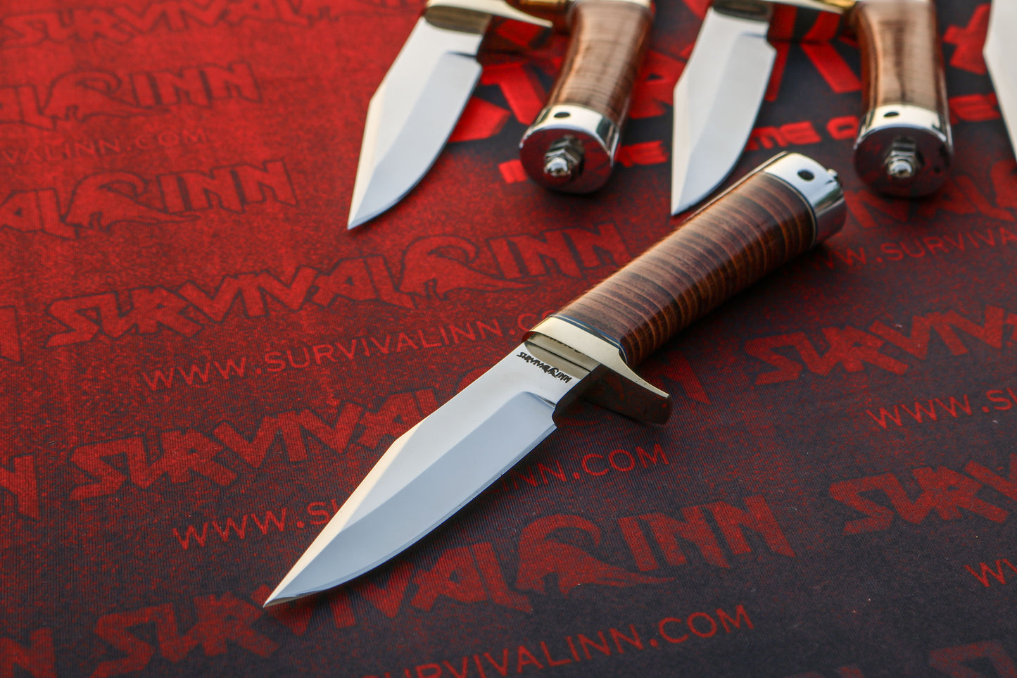 Precise junction of the brass hilt and stacked leather grip on a custom Randall Model 8 knife.
