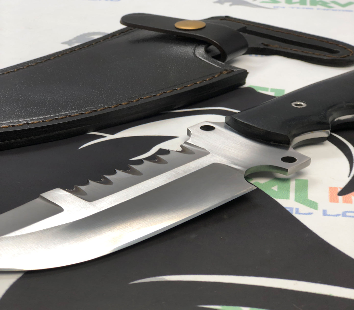 Sharp tactical knife blade with serrated edge, designed for hunting and survival tasks