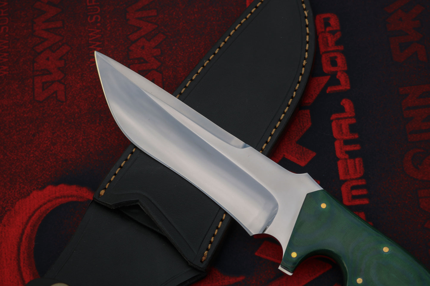 Close-up of D2 tool steel blade highlighting thickness, bevel grind, and rugged Bowie profile