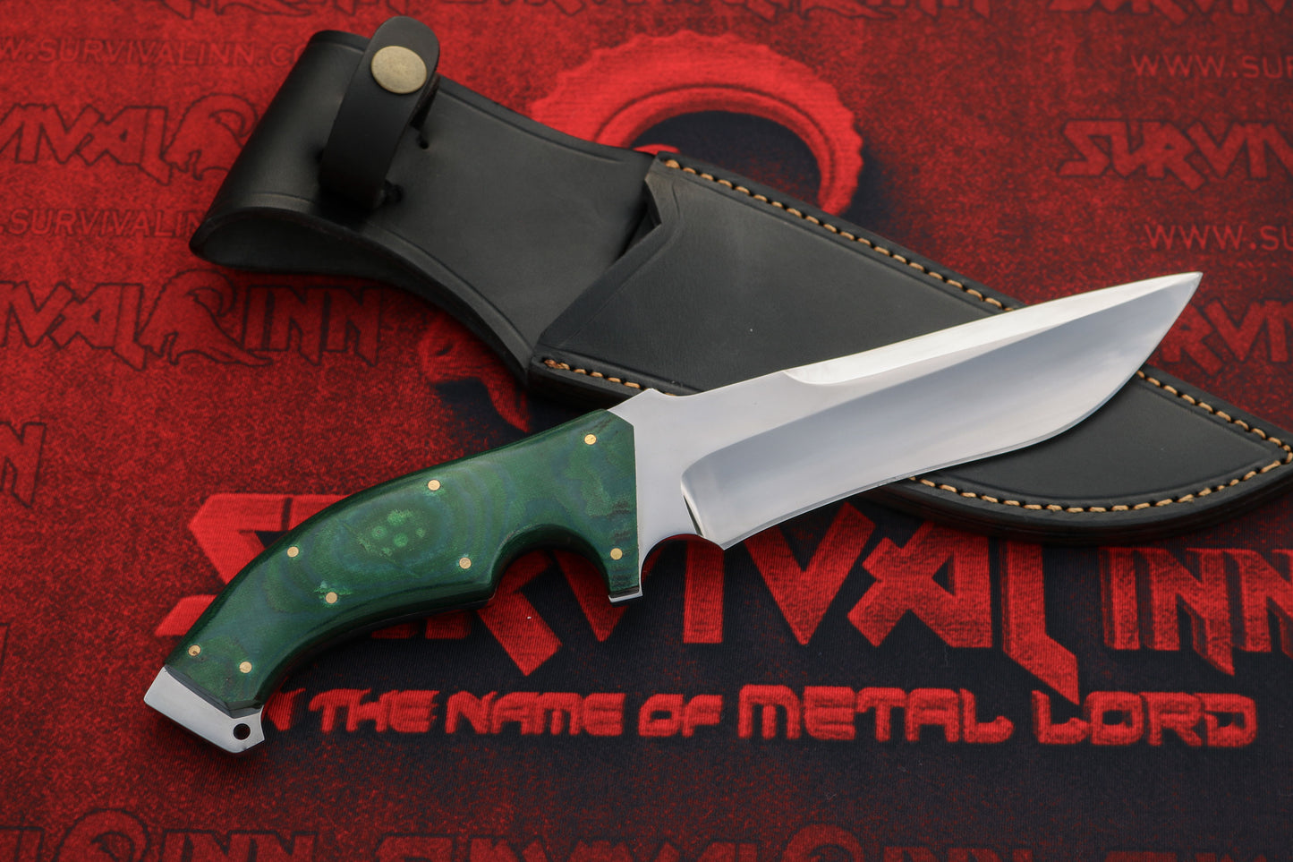 Handmade D2 steel Bowie knife blade close-up showing grind lines and sharp edge finish