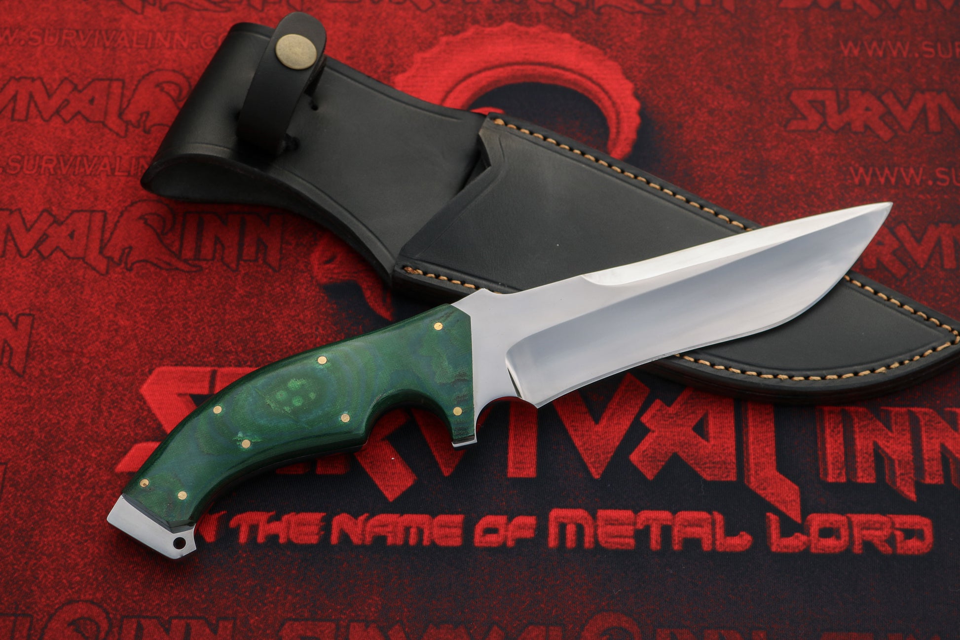 Handmade D2 steel Bowie knife blade close-up showing grind lines and sharp edge finish