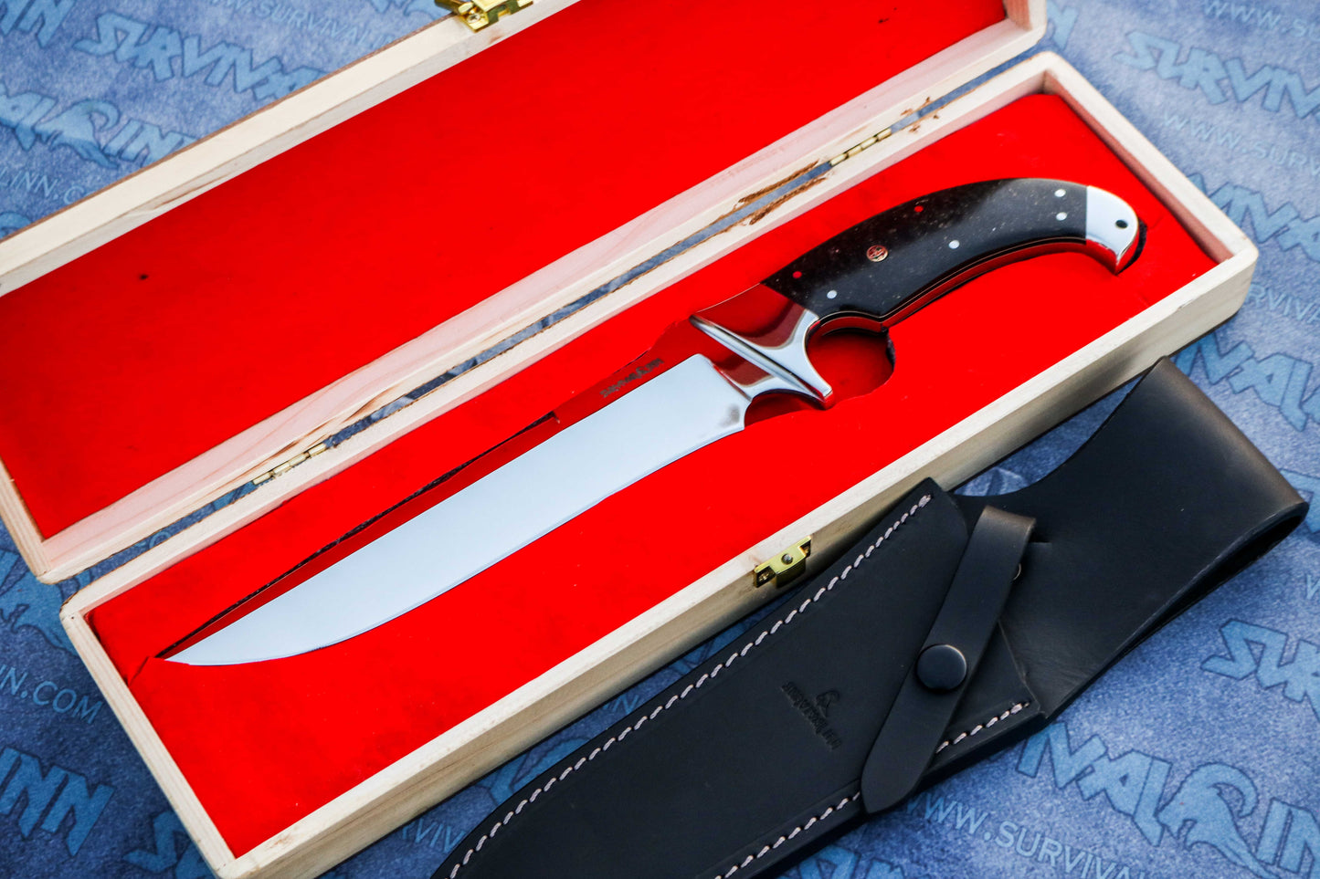 Collector-grade Bowie knife with galaxy micarta handle placed in wooden display box”