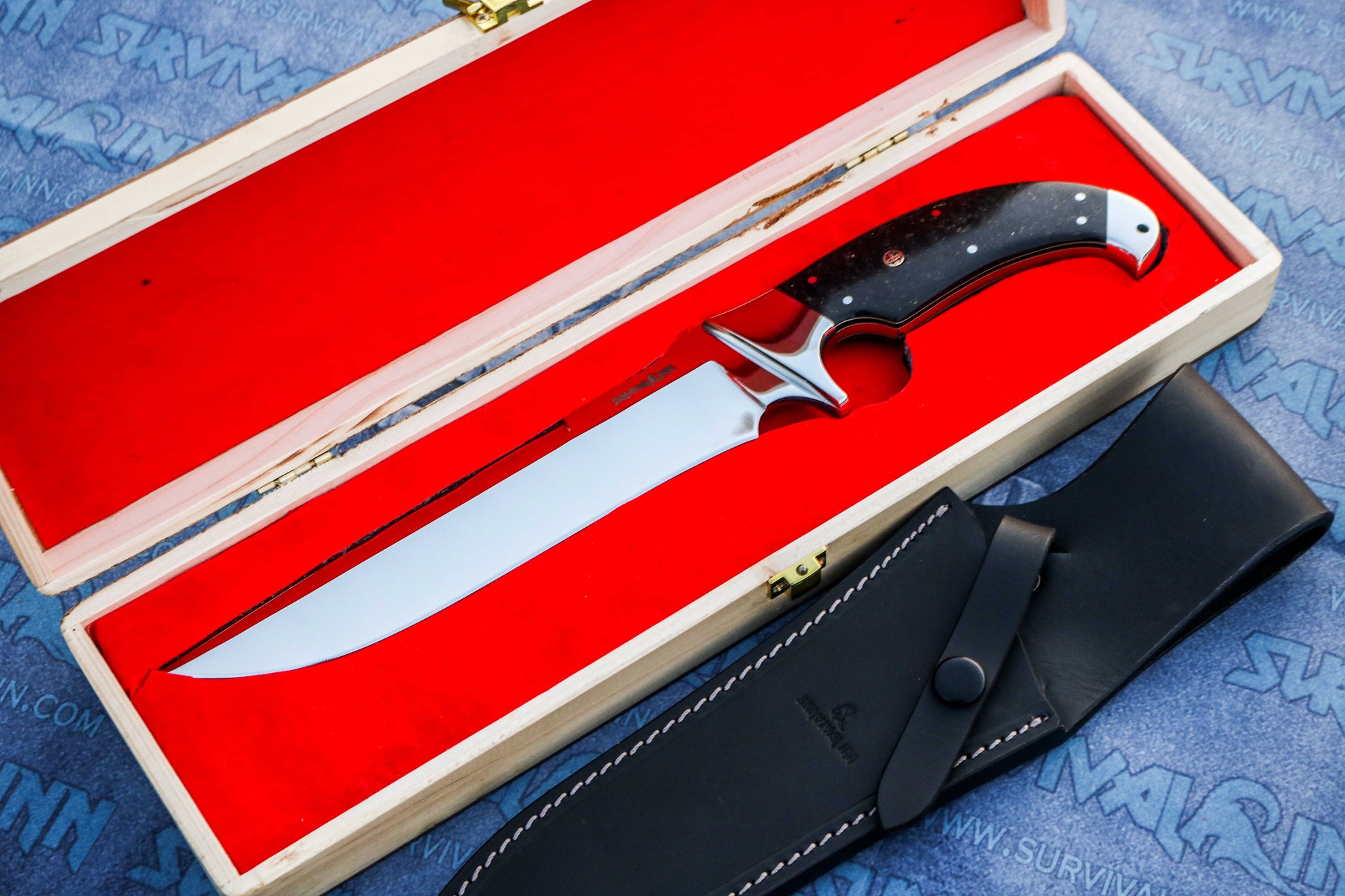 Collector-grade Bowie knife with galaxy micarta handle placed in wooden display box”