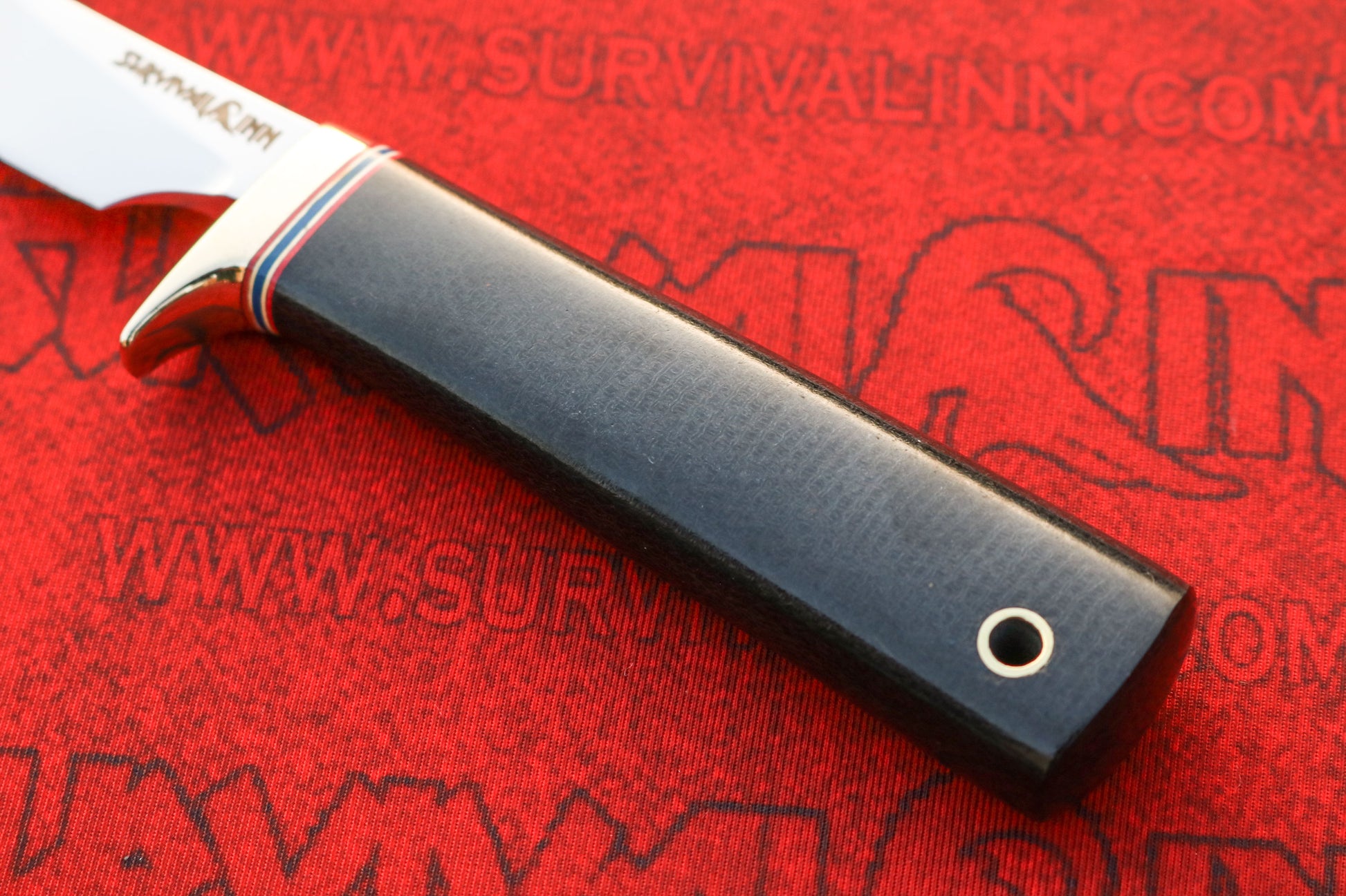 Close-up of Randall Model 20 hunting knife Micarta handle with brass guard and thumb rest