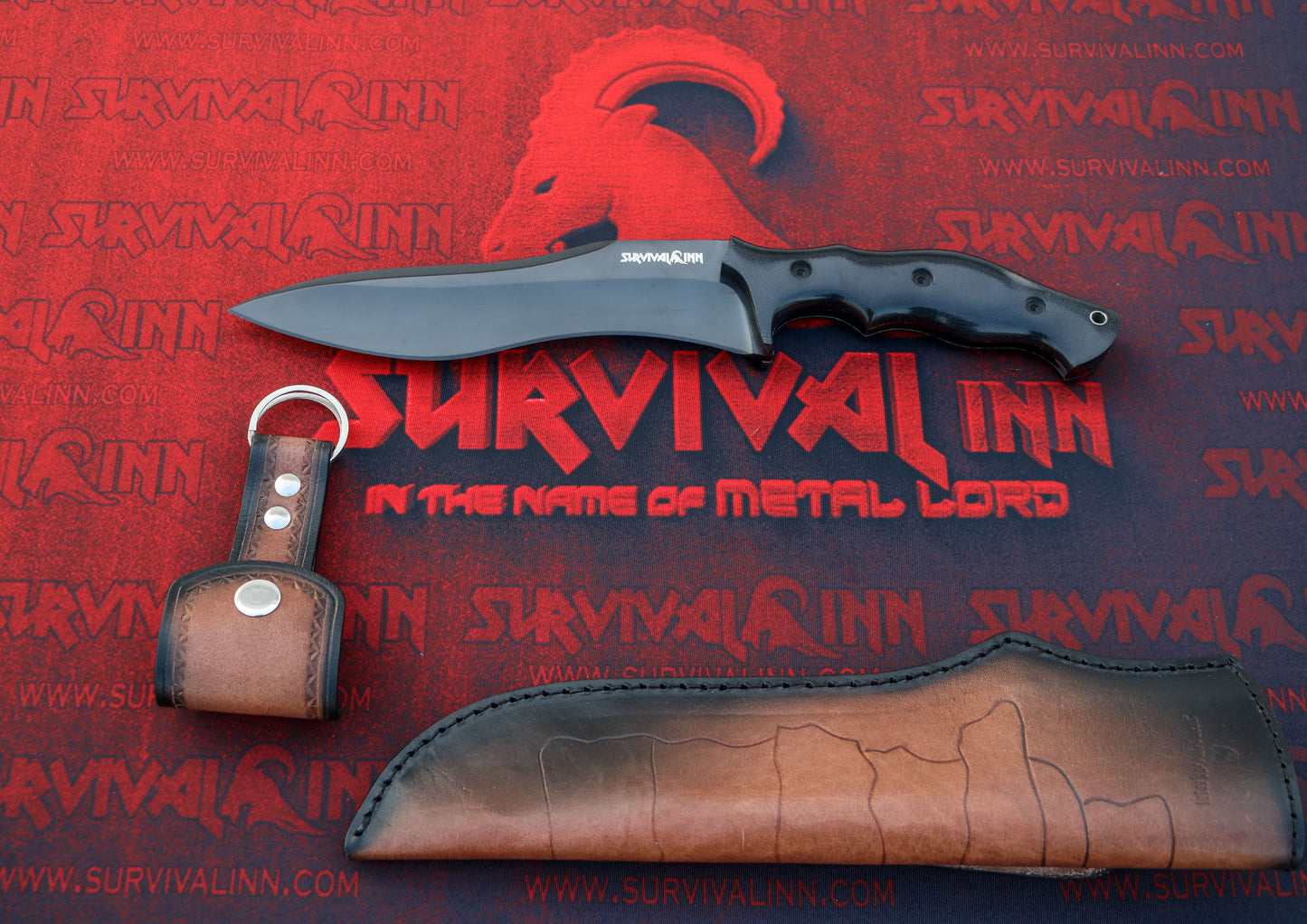 Knife with leather sheath and keychain on a red 'Survival Inn' background