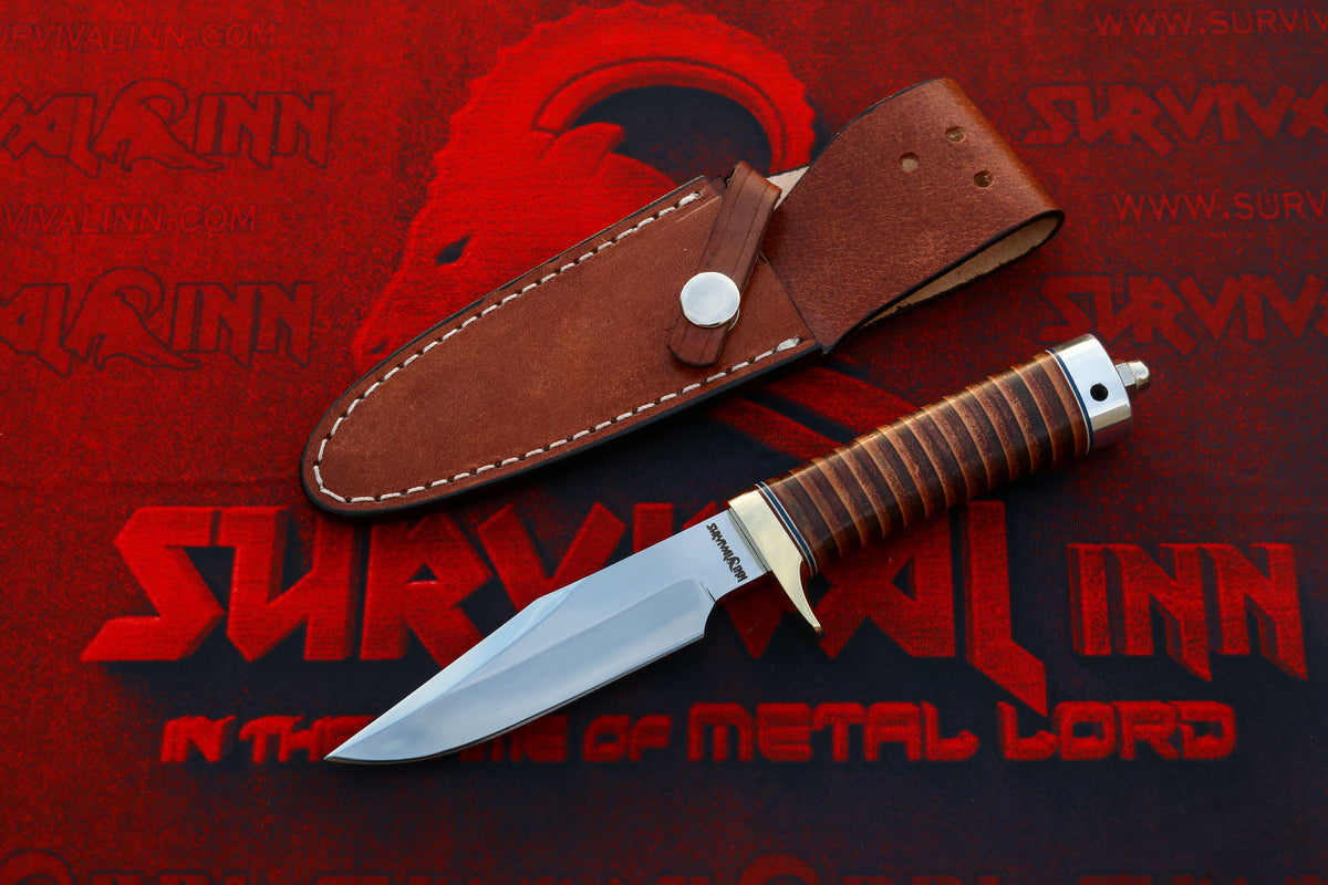 A fixed-blade survival knife with a silver blade and brown wrapped handle, displayed next to its brown leather sheath on a red and black graphic background with the text 'SURVIVAL INN'.