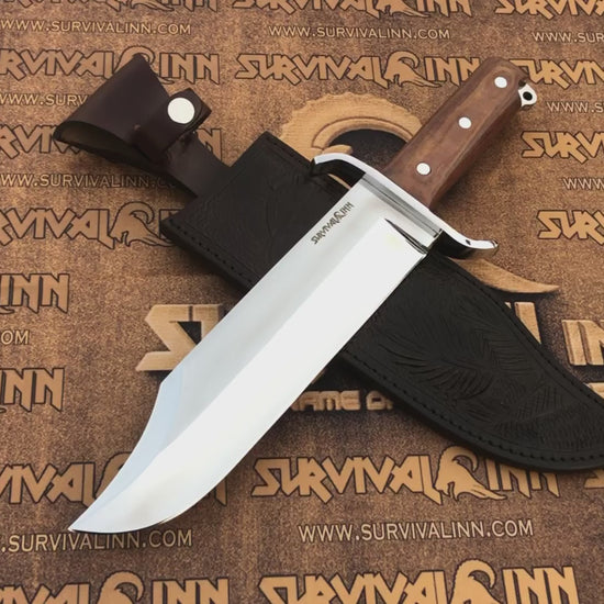 Product hero shot of the handmade 5160 steel bowie knife next to the artisan logo, built to be an heirloom survival tool